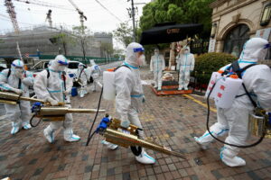 Volunteers in protective suits prepare to disinfect a residential compound in Huangpu district, to curb the spread of the coronavirus disease (COVID-19), in Shanghai, China April 14, 2022. China Daily via REUTERS ATTENTION EDITORS - THIS IMAGE WAS PROVIDED BY A THIRD PARTY. CHINA OUT.